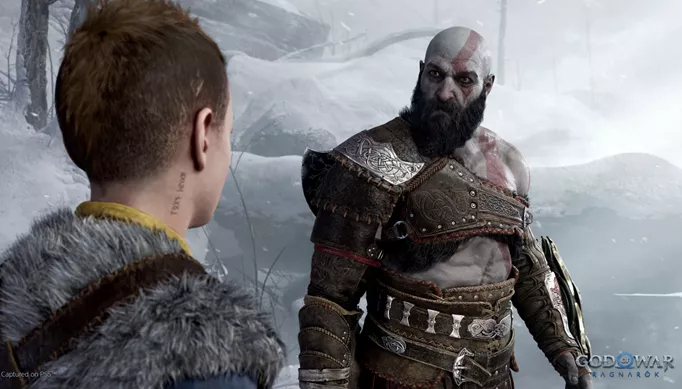 Kratos looks at Atreus in God of War: Ragnarok.